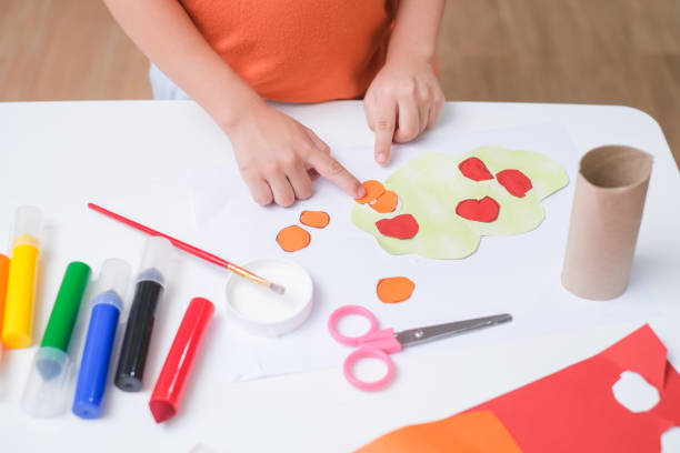 top view of little 3 years old toddler boy enjoy using glue doing arts at home, fun paper and glue crafts for toddlers, children's art project - 2 3 years fotos imagens e fotografias de stock