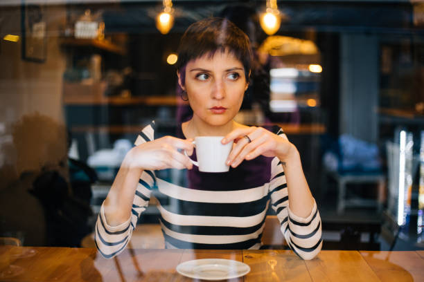 istock Woman drinking coffee at the cafe 1179770199