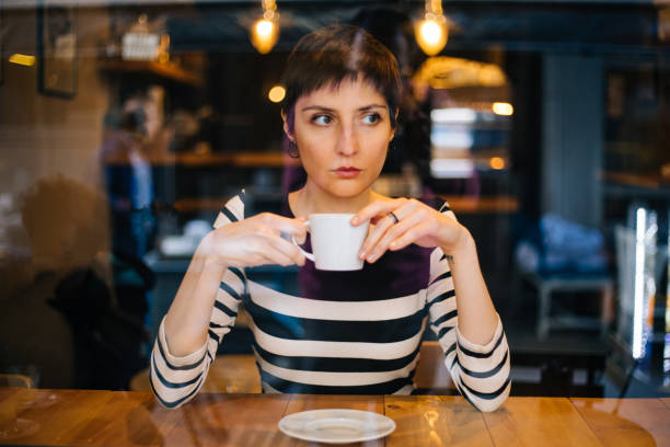 istock Woman drinking coffee at the cafe 1179770200