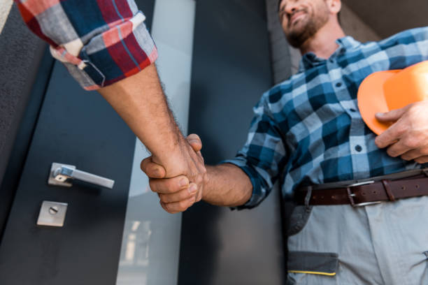 istock cropped view of men shaking hands while standing near door 1179770536