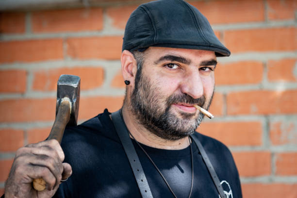 istock Portrait. head-shot of blacksmith worker smokes after hard work. 1179770930