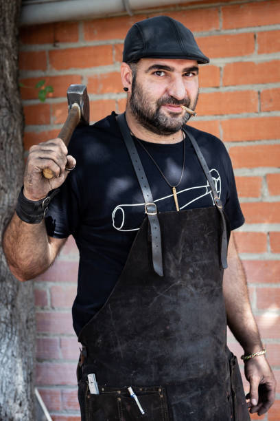 istock Portrait of blacksmith worker smokes after hard work. 1179770933