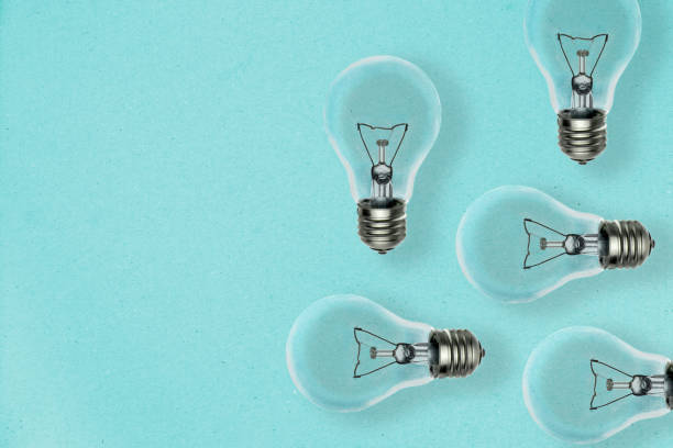 istock Idea concept background with many light bulbs dropping shadow on a blue paper sheet and copy space for your text 1179770977