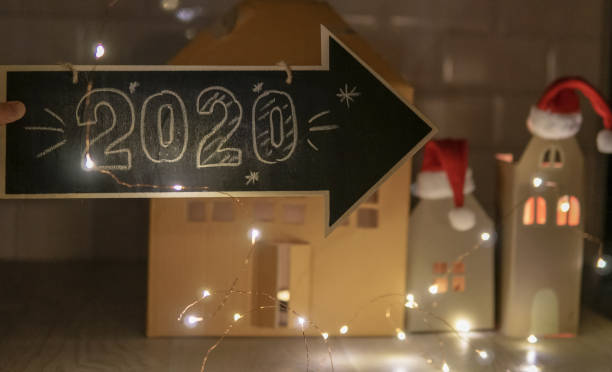 istock Christmas background with man holding an arrow with 2020 1179775287