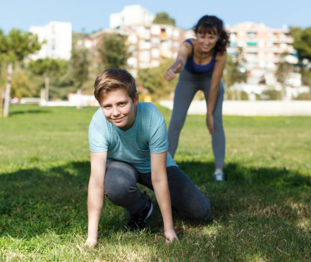 istock Mother and son stretching outdoors 1179776076