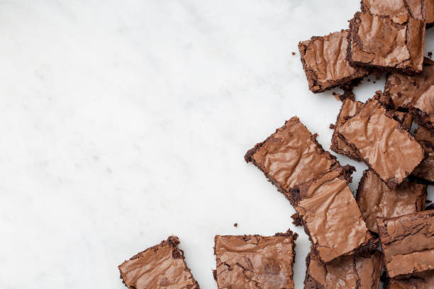 istock Chocolate brownies cakes deserts on a white marble background looking down top view 1179777236