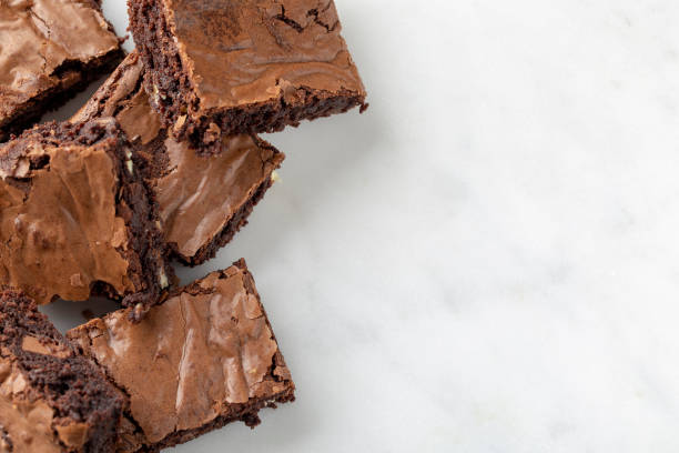 istock Chocolate brownies cakes deserts on a white marble background looking down top view 1179777296