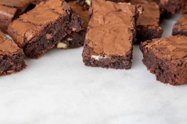 istock Chocolate brownies cakes deserts on a white marble background looking down top view 1179777311