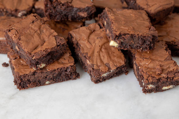 istock Chocolate brownies cakes deserts on a white marble background looking down top view 1179777376