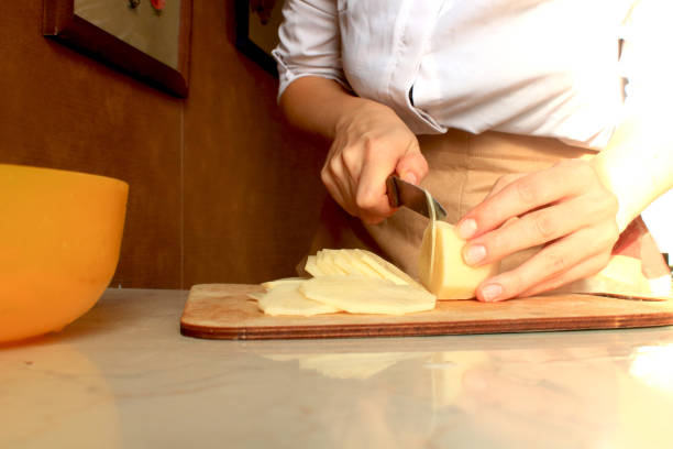 istock Woman's  hands cutting fresh potatoes 1179777805