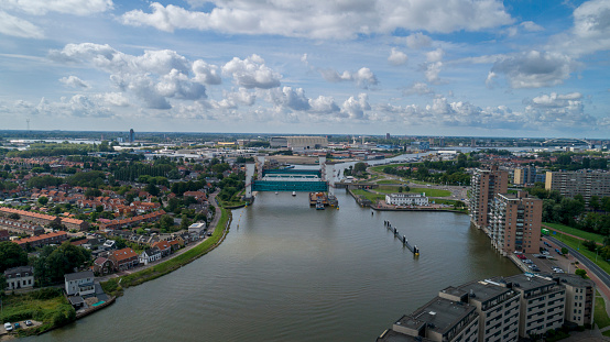 the lifted Algera flood barrier in the river Hollandse IJssel in the background on a sunny day in summertime