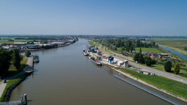 istock Loading barge with sand and rubble on a small berth. Freight transport logistics 1179778997