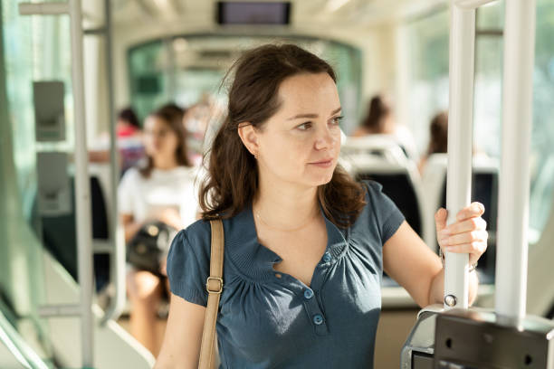 istock Smiling brunette in public transport 1179779309