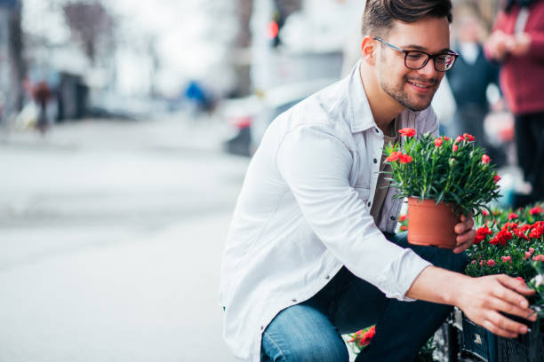 istock Young man buying flowers. 1179779747