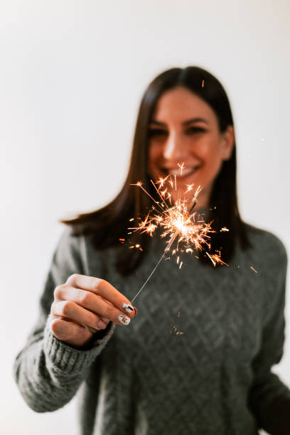 istock Happy woman holding bengal lights. 1179779763