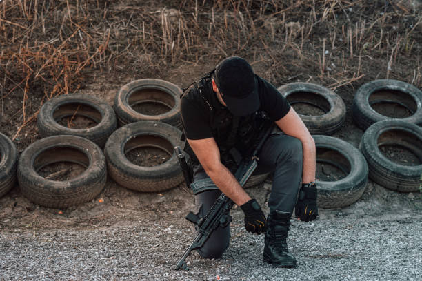 istock Armed guy tying a shoelace outdoors. 1179779880