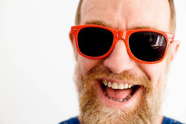 istock Middle-aged bearded man in red sunglasses laughs happily 1179781079