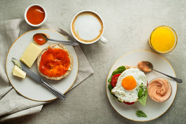 istock Breakfast served with orange juice, sandwich with egg, jam with butter 1179781782