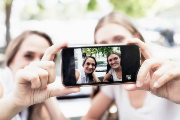 istock Two young women take a happy selfie together 1179782627