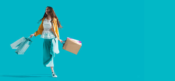 istock Cheerful young woman enjoying shopping 1179784930