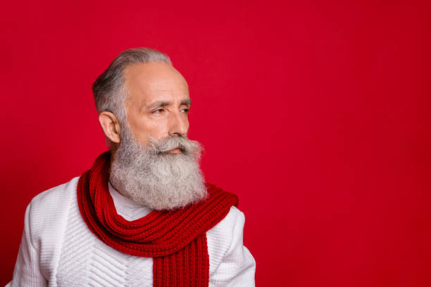 istock Close up profile side photo of gorgeous elderly man looking wearing white pullover isolated over red background 1179787393