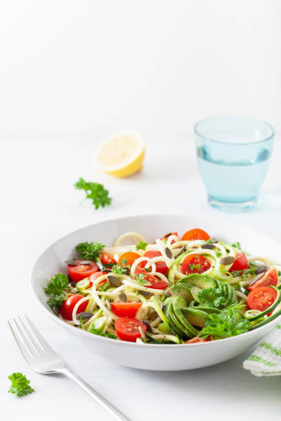 istock vegan ketogenic spiralized courgette salad with avocado tomato pumpkin seeds 1179787556
