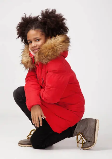 Photo of Cute teenage girl in red winter parka