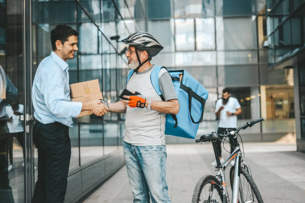 istock Businessman taking his order from the delivery man 1179790198