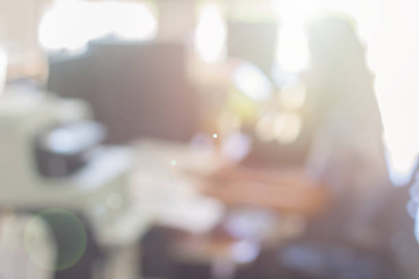istock Businessman blur in the workplace at sitting on a computer screen work space of table work in office with fax, document division and printer or shallow depth of focus horizontal abstract background. 1179790359