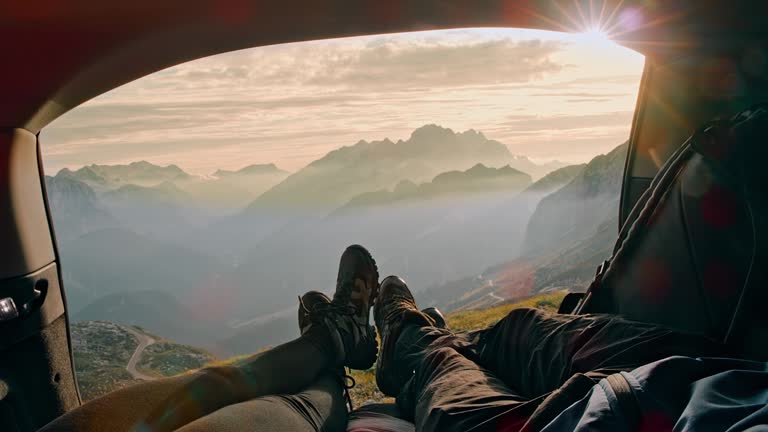 MS Two campers resting in the trunk of the car in mountains