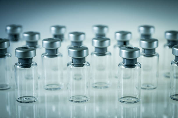 istock Vaccine glass bottles on grey background 1179790914