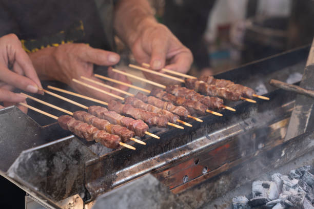 istock Man cooking meat on grill 1179791947