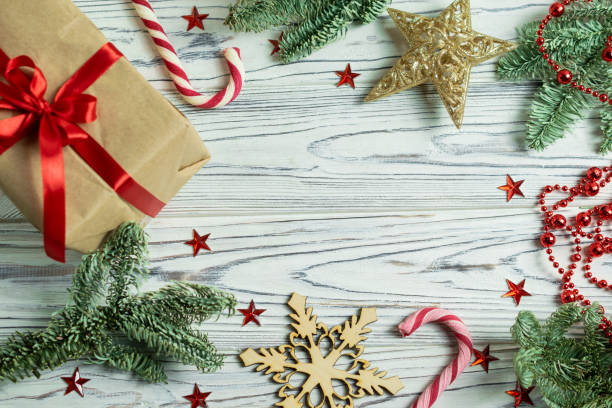 istock Christmas frame decorations with fir tree branches, present, candy cane, snowflakes and stars with copy space for your text. Overhead flat lay 1179792064