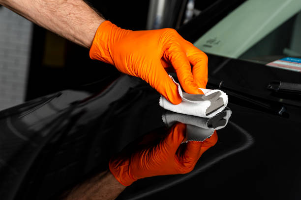 istock Car polish wax worker hands polishing car. 1179792274