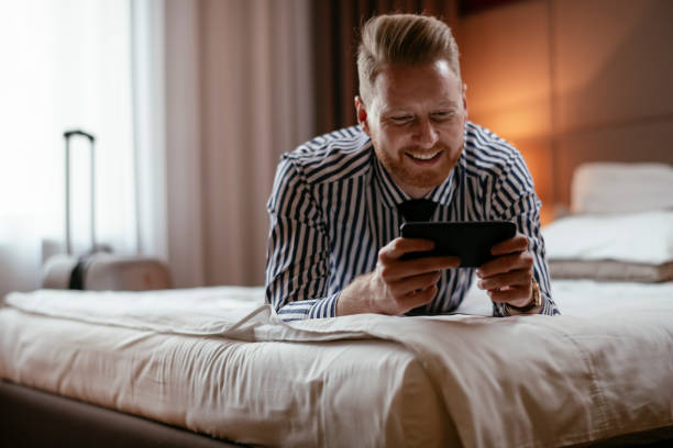 istock Businessman using phone in hotel room 1179792319