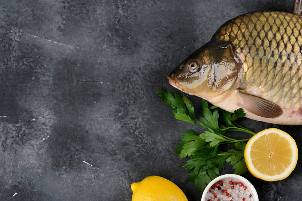 istock Raw carp on a dark surface. Products concept for the festive table. 1179792371