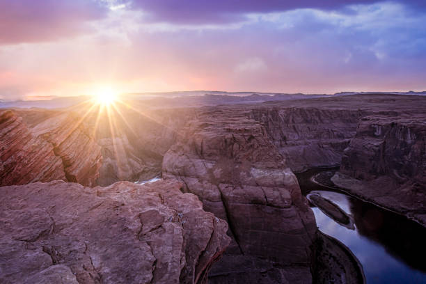 istock Dramatic sunset with sun rays in horseshoe bend canyon in Page Arizona 1179792440