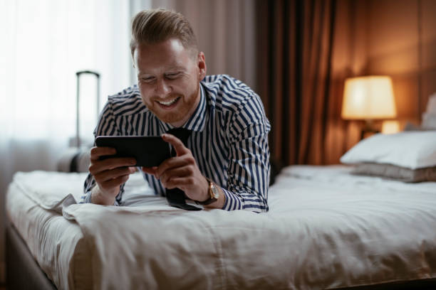 istock Businessman using phone in hotel room 1179792566