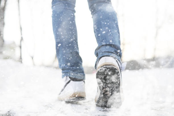 istock A man walks through the city on snowy winter day. 1179794692