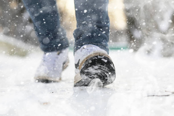 istock A man walks through the city on snowy winter day. 1179794726