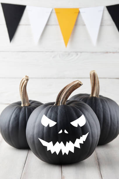 istock Halloween black pumpkins with scary faces 1179794952