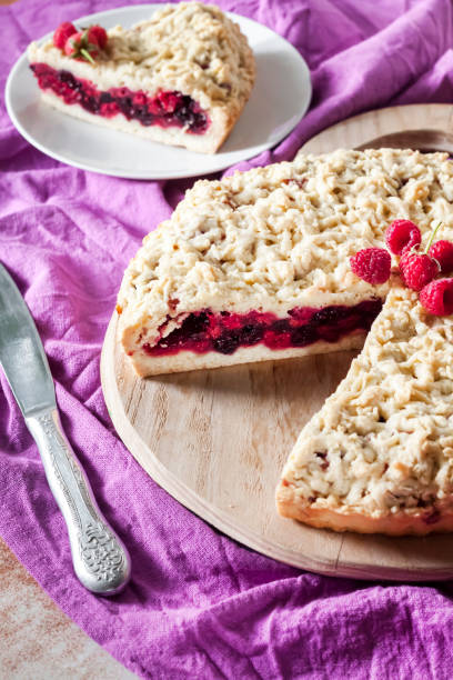istock Homemade berry shortcrust pie with crumble on wooden board 1179796557