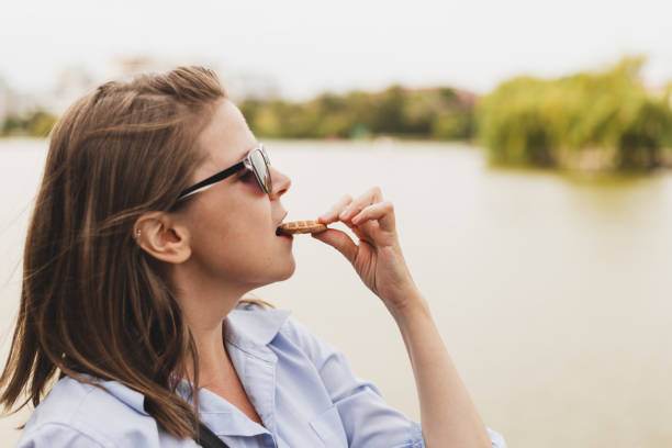 istock Woman eating a biscuit outdoors 1179798656