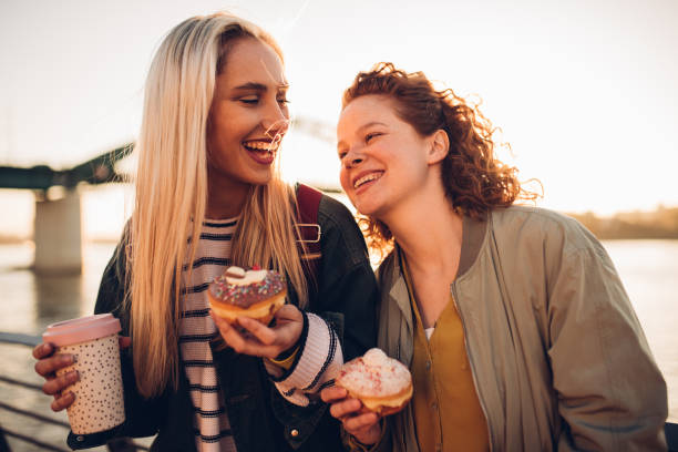 istock Girls having coffee and donuts 1179798938