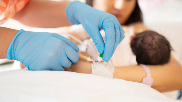istock Nurse with blue gloves inputs catheter in patient hand 1179804517