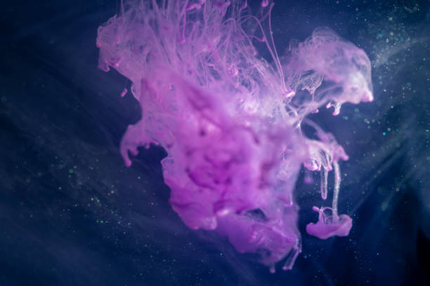istock Pink ink in the water isolated on black background 1179804912