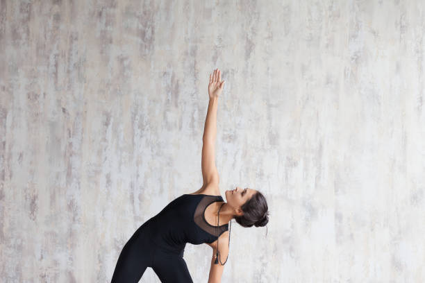istock Young attractive woman practicing yoga and stretching body. 1179806742