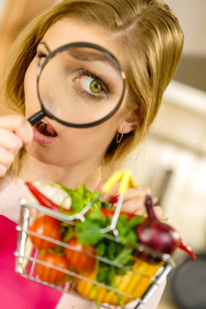 istock Woman investigating shopping backet with vegetables 1179807608