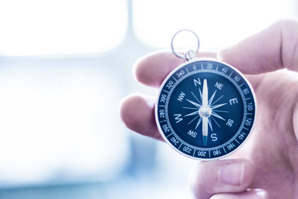 istock Innovation concept: Man is holding a compass in his hand, closeup cutout 1179810153