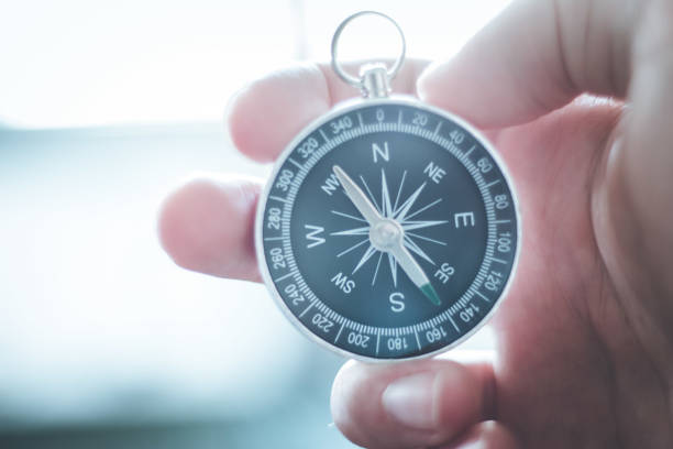 istock Innovation concept: Man is holding a compass in his hand, closeup cutout 1179810900